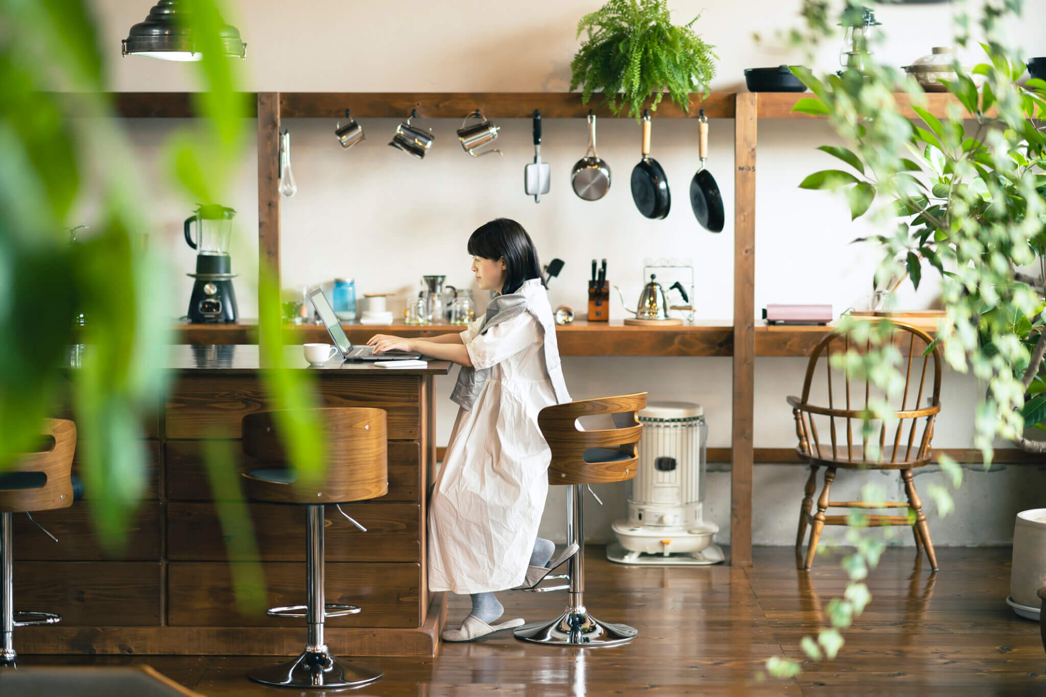 A woman looking at a laptop screen in a warm atmosphere