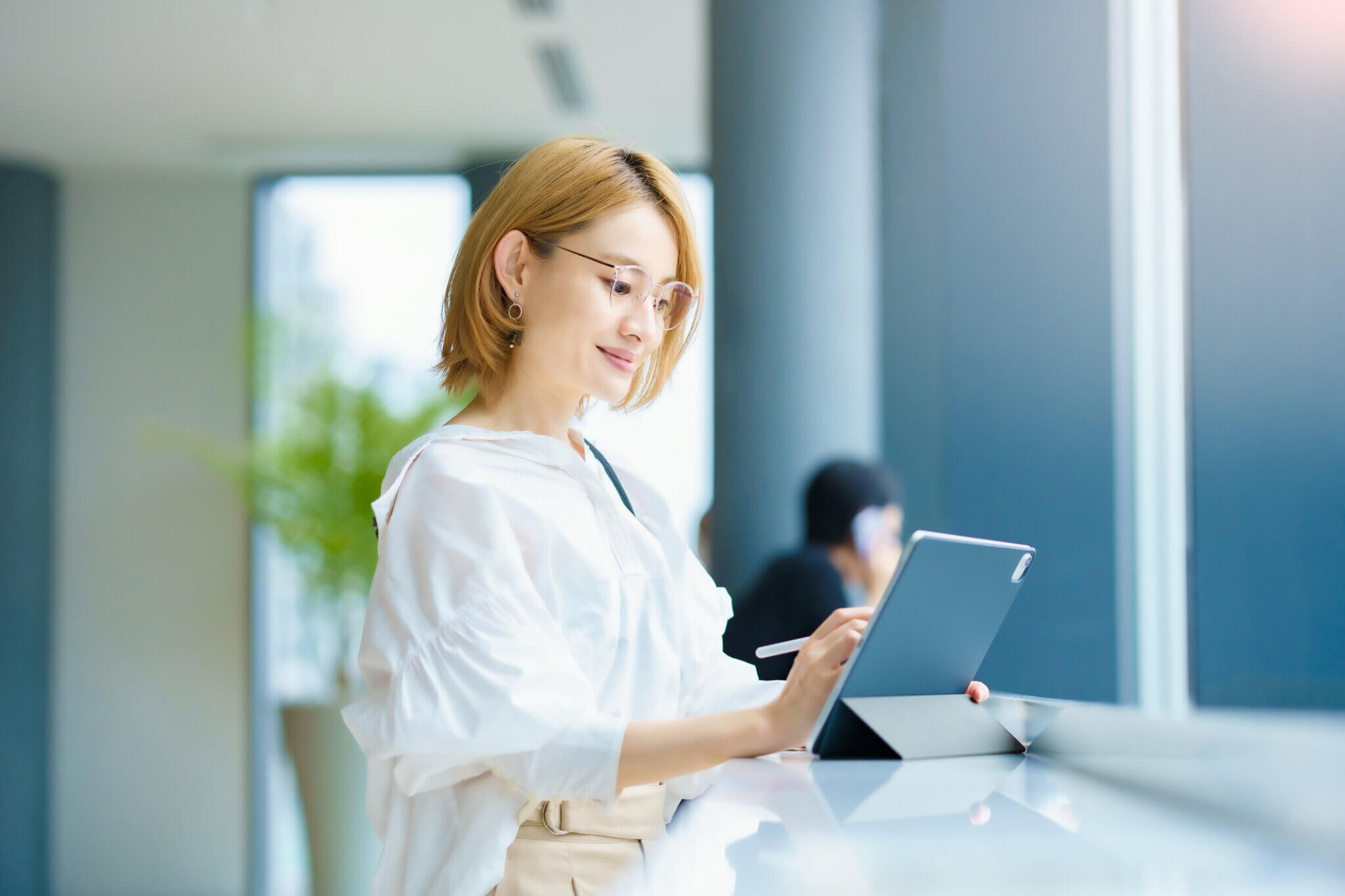 Asian woman operating a tablet PC in the city